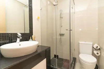 a bathroom with a sink and a toilet and a shower at appartement luxe golf prestigia in Marrakech