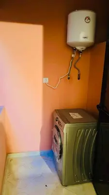 a washing machine in a corner of a room at Spacieux appartement juste pour familles réservation juste pour les familles et les couples mariés in Marrakech