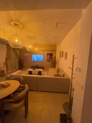 a living room with a couch and a table at Cosy Victor hugo in Marrakech