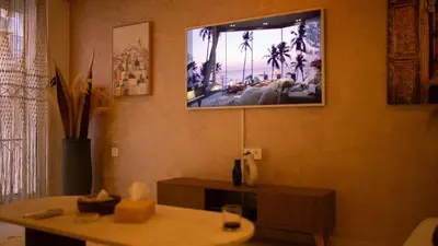 a living room with a tv hanging on the wall at Cosy Victor hugo in Marrakech
