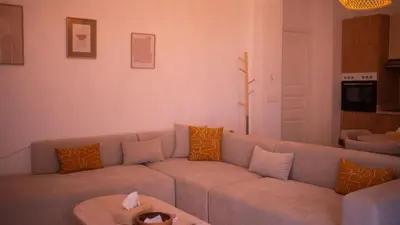 a living room with a couch and a table at Cosy Victor hugo in Marrakech