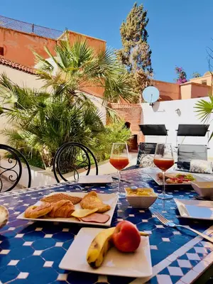 a table with glasses of wine and food on it at bel appartement in Marrakech