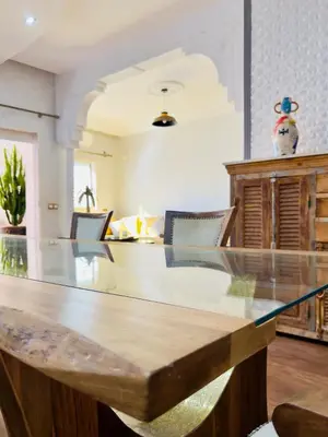 a large dining room with a glass table at bel appartement in Marrakech