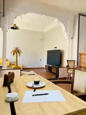 a table with a cup of coffee on top of it at bel appartement in Marrakech