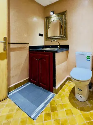 a bathroom with a toilet and a sink at bel appartement in Marrakech