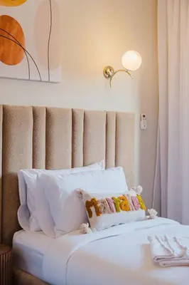 a white bed with white pillows in a room at 3BR Luxury Stay - Hivernage- Pool View - Parking Near M Avenue & Rail in Marrakech