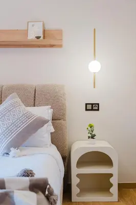 a bedroom with a bed with a side table at 3BR Luxury Stay - Hivernage- Pool View - Parking Near M Avenue & Rail in Marrakech