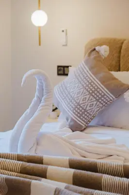 a white bed with a swan made out of towels at 3BR Luxury Stay - Hivernage- Pool View - Parking Near M Avenue & Rail in Marrakech