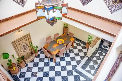 an overhead view of a dining room with a table and checkered floor at Riad Palm and Pool 2 in Marrakech