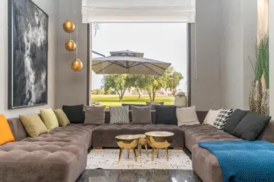 a living room with a large couch and tables at jacuzzi, 2 pools, luxury villa in Marrakech