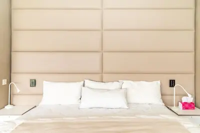 a bedroom with a bed with white pillows at jacuzzi, 2 pools, luxury villa in Marrakech