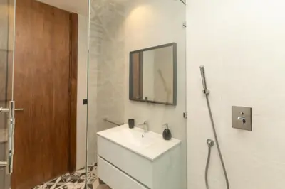 a bathroom with a white sink and a mirror at jacuzzi, 2 pools, luxury villa in Marrakech