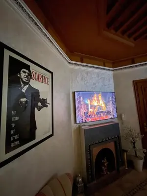 a living room with a tv and a fireplace at Ma kech house in Marrakech