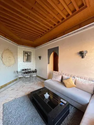 a living room with a couch and a table at Ma kech house in Marrakech