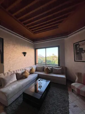 a living room with a couch and a large window at Ma kech house in Marrakech