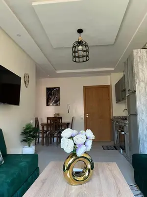 a living room with a vase with flowers on a table at Global riad nawal in Marrakech