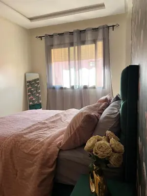 a bedroom with a bed and a window withimov at Global riad nawal in Marrakech