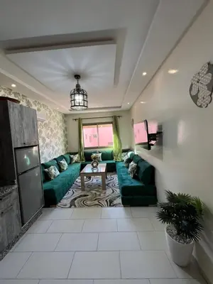 a living room with green couches and a table at Global riad nawal in Marrakech
