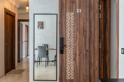 a mirror in a room with a table and a dining room at Cocon Sable piscine et parking in Marrakech