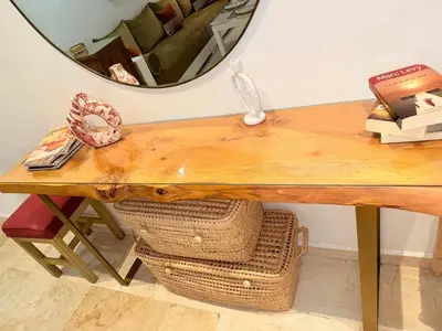 a wooden table with a mirror on the wall at appartement familial in Marrakech