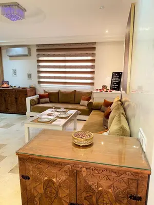 a living room with a couch and a table at appartement familial in Marrakech