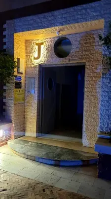 an entrance to a brick building with a black door at appartement familial in Marrakech