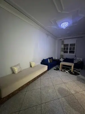 a room with a bed and a couch and a table at Targa in Marrakech