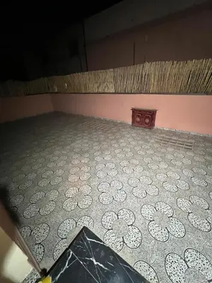 an empty room with a tiled floor with a table at Targa in Marrakech