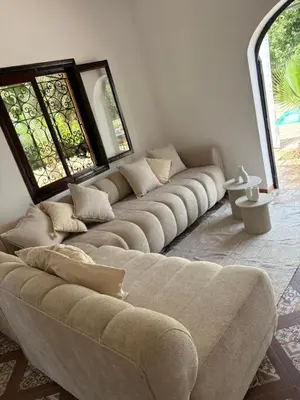 a living room with a couch and two windows at L ÉdenS in Marrakech