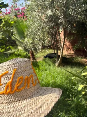 a straw hat sitting in a field of grass at L ÉdenS in Marrakech