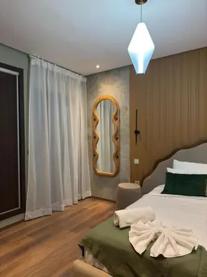 a bedroom with a bed and a mirror at Magnifique appart Moderne 2ch 4pax Tout Confort in Marrakech