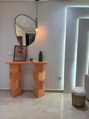 a mirror sitting on top of a table in a room at Magnifique appart Moderne 2ch 4pax Tout Confort in Marrakech