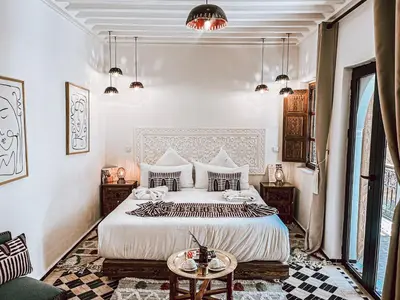 a bedroom with a large bed and a table at Marrakech Riads, NL Collection in Marrakech