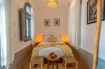 a bedroom with a bed with a bowl of fruit on a table at Marrakech Riads, NL Collection in Marrakech