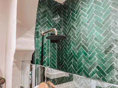 a bathroom with a green tiled wall with a sink at Marrakech Riads, NL Collection in Marrakech