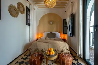a bedroom with a bed and a table with fruit on it at Marrakech Riads, NL Collection in Marrakech