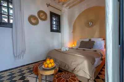 a bedroom with a bed and a table with oranges on it at Marrakech Riads, NL Collection in Marrakech