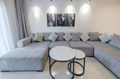 a living room with a couch and a table at Prestige de luxe avec piscine in Marrakech