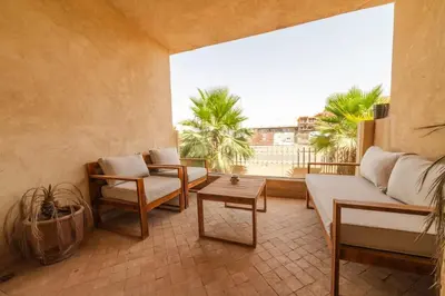 a living room with a couch and a table at Prestige de luxe avec piscine in Marrakech