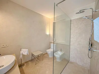 a bathroom with a shower and a toilet and a sink at Riad Timija in Marrakech