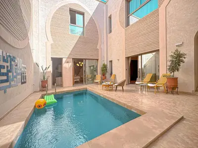 a pool with a toy in the middle of a building at Riad Timija in Marrakech