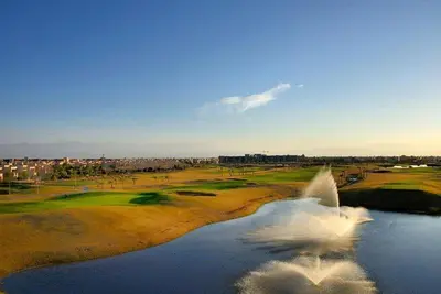 a white bird flying over a golf course at Luxury Stay - Prestigia Golf City-3min - Airport in Marrakech