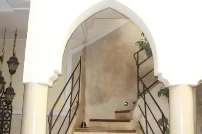 an entrance to a building with an arch and stairs at Riad Light Of Sun in Marrakech