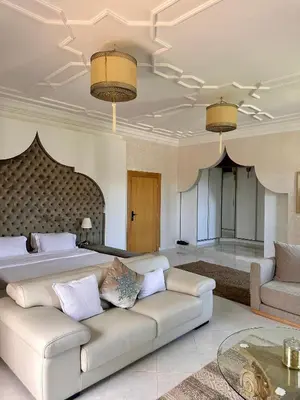 a living room with a couch and a bed at Villa luxueuse marrakech in Marrakech