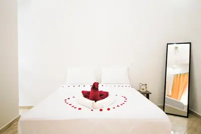 a bedroom with a white bed with a red object on it at Redmoon Villa & Riad in Marrakech
