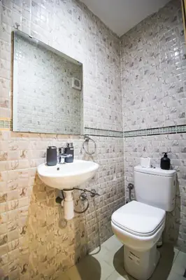 a bathroom with a sink and a toilet and a mirror at Redmoon Villa & Riad in Marrakech