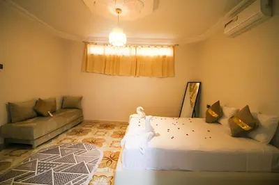 a bedroom with a large bed and a couch at Redmoon Villa & Riad in Marrakech