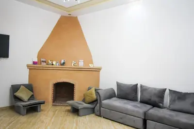 a living room with a couch and a fireplace at Redmoon Villa & Riad in Marrakech
