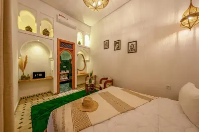 a bedroom with a bed with a hat on it at Riad AL-Ghazlan Hamam & Spa in Marrakech