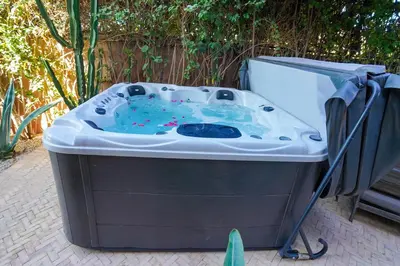 a large hot tub sitting on a patio at Villa centre Marrakech piscine sans vis-à-vis et Jacuzzi in Marrakech